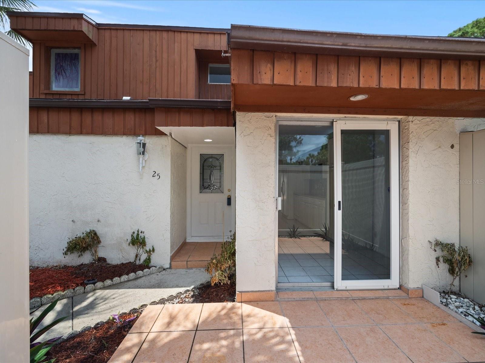 Front patio with sliders leading to kitchen