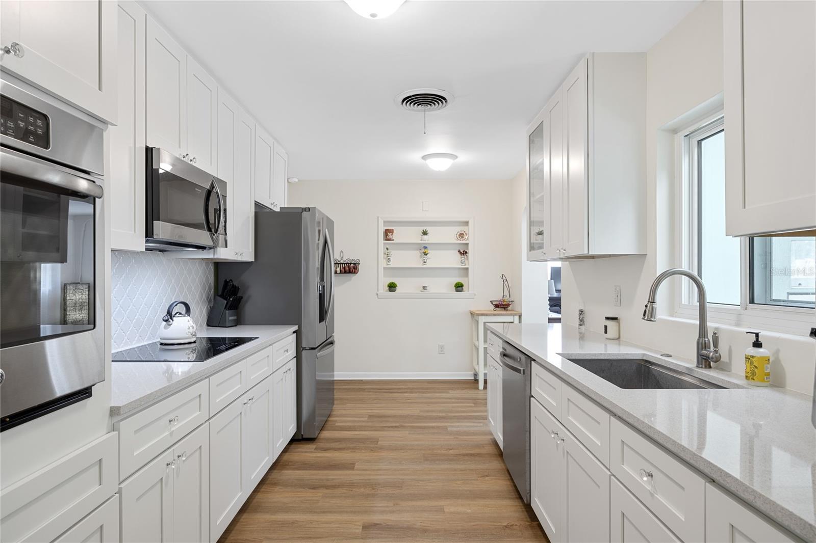 This Kitchen is beautifully updated with gorgeous stone countertops and tall cabinets for plenty of storage.