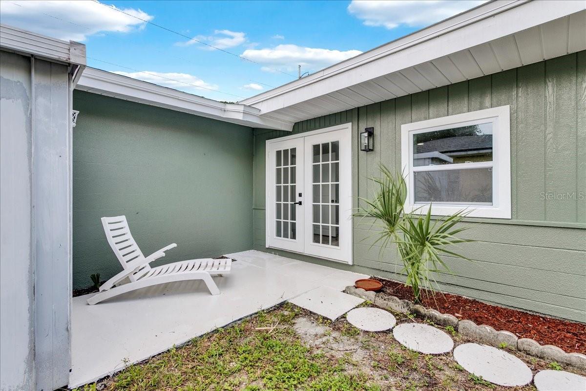 Open patio with shed storage.