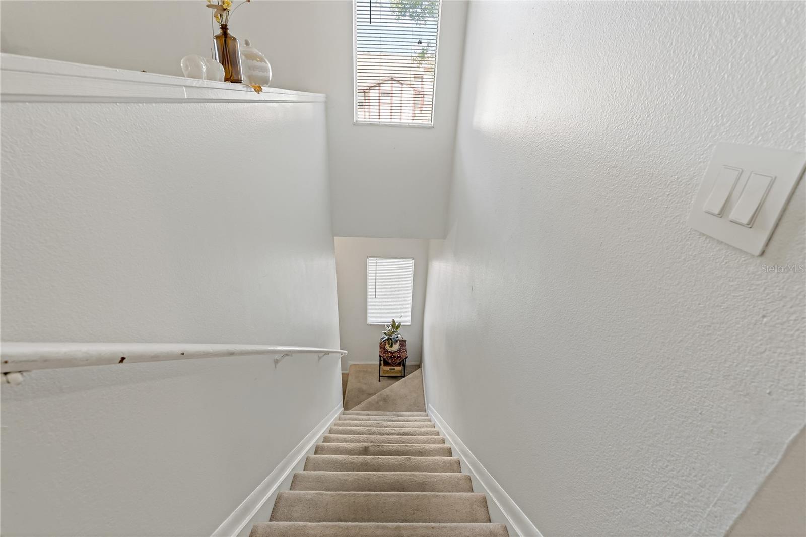 Stairs leading to the downstairs front door