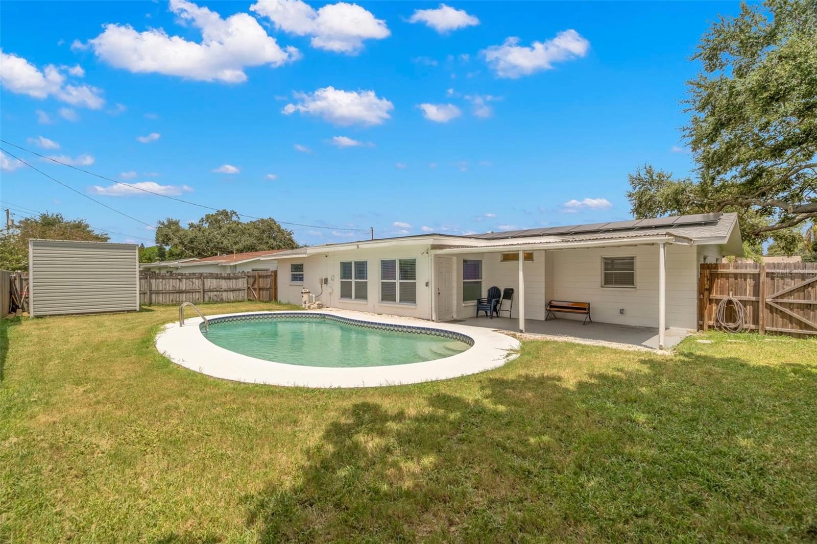 Backyard with chlorine, in-ground pool.