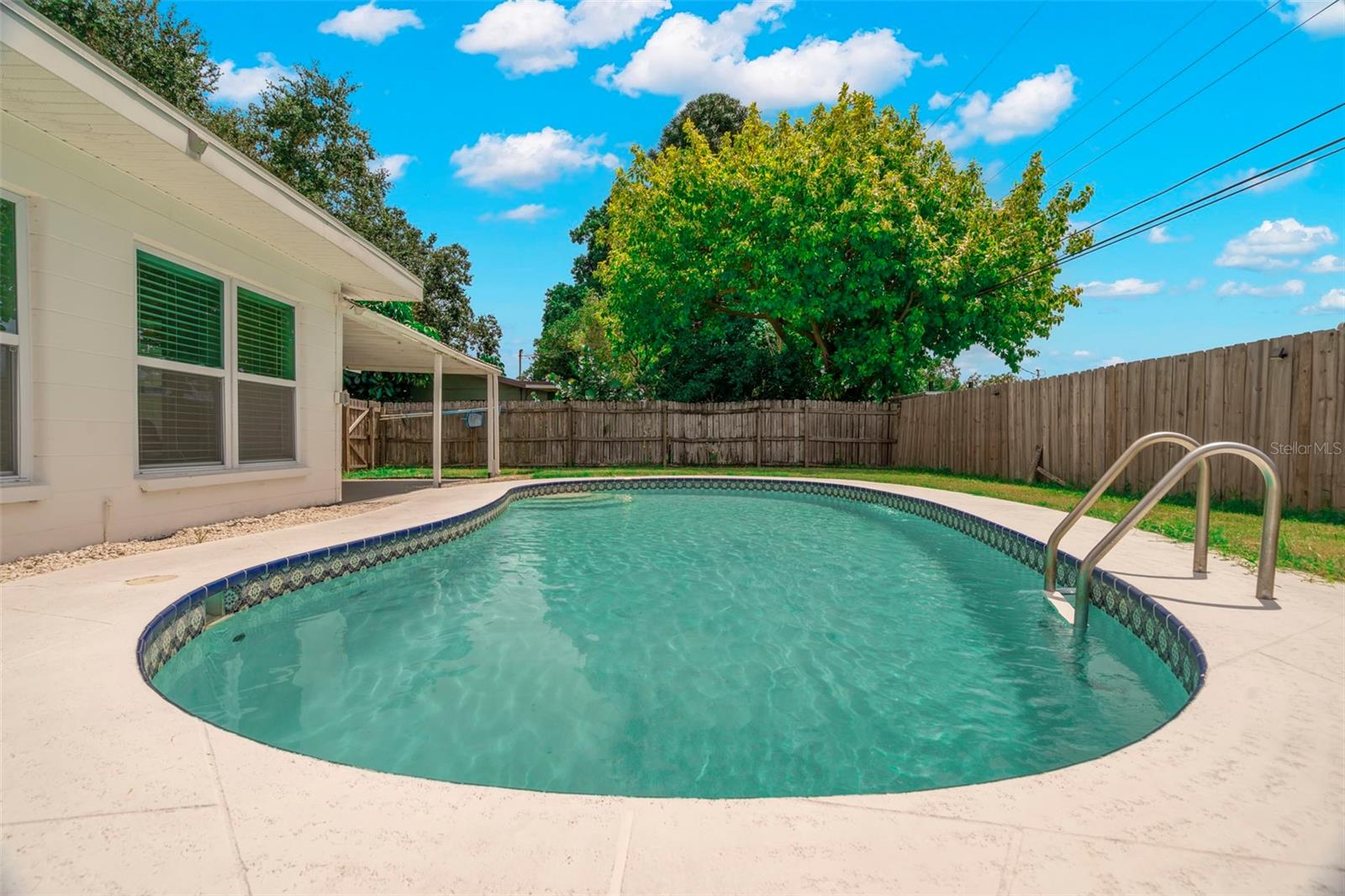 Backyard with chlorine, in-ground pool.