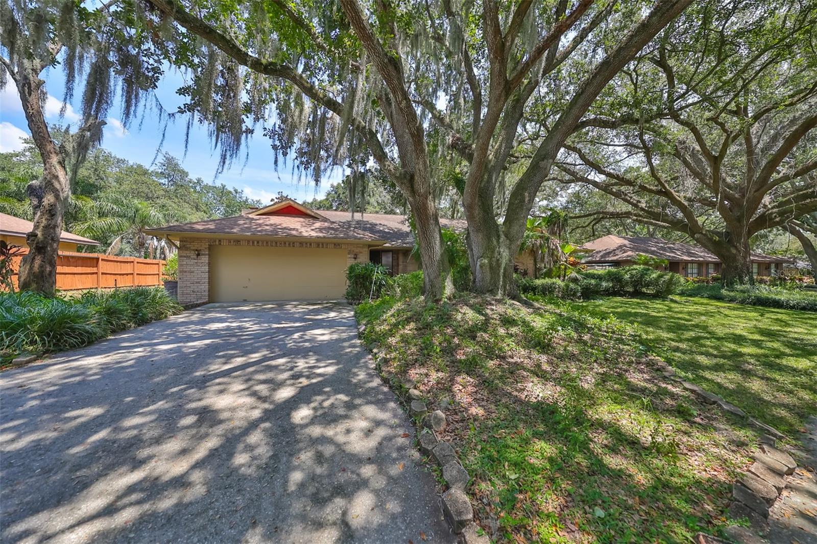 Deep driveway and majestic oak trees.