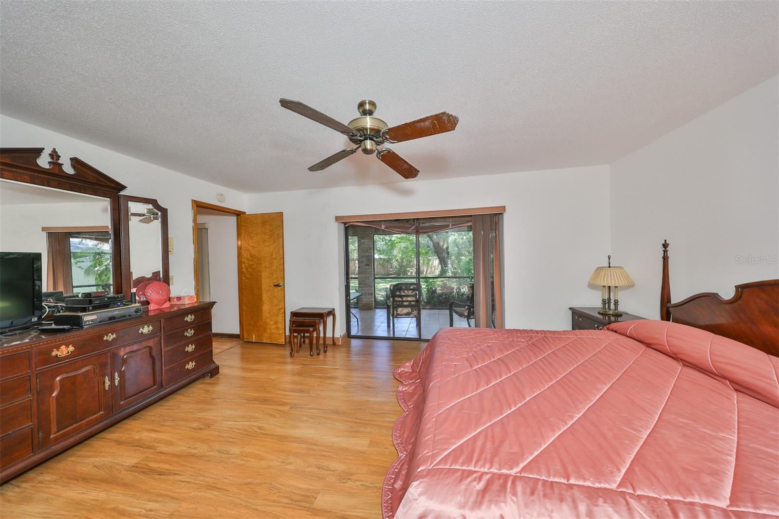 Primary Bedroom has sliding glass doors that lead to the screened lanai.