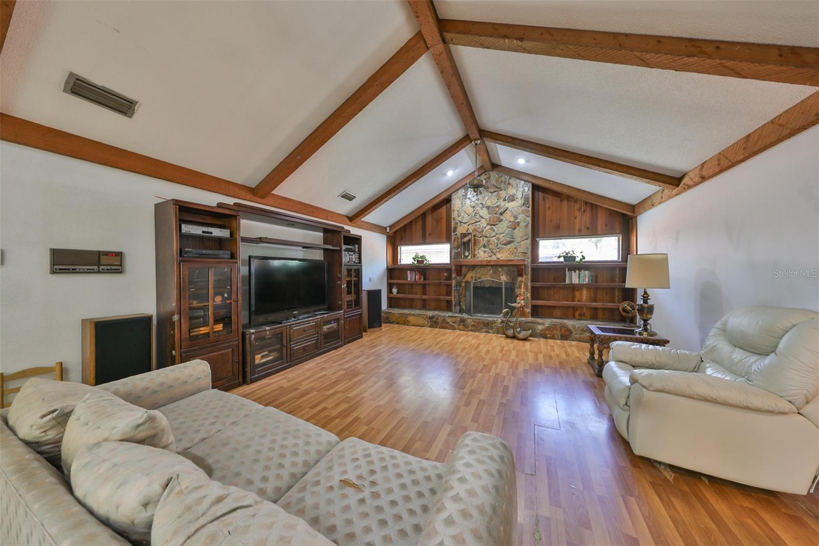 Family room is HUGE with a fireplace, ceiling beams and cathedral ceilings.