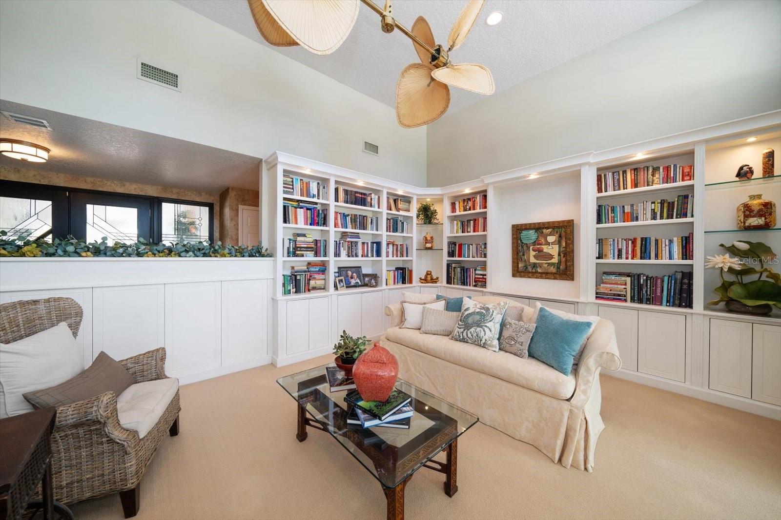 Formal living room with custom built in shelving