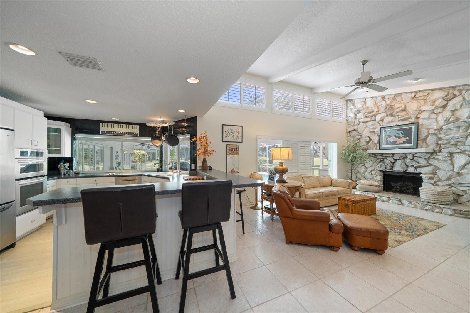 Bar stool seating off the kitchen into the family room