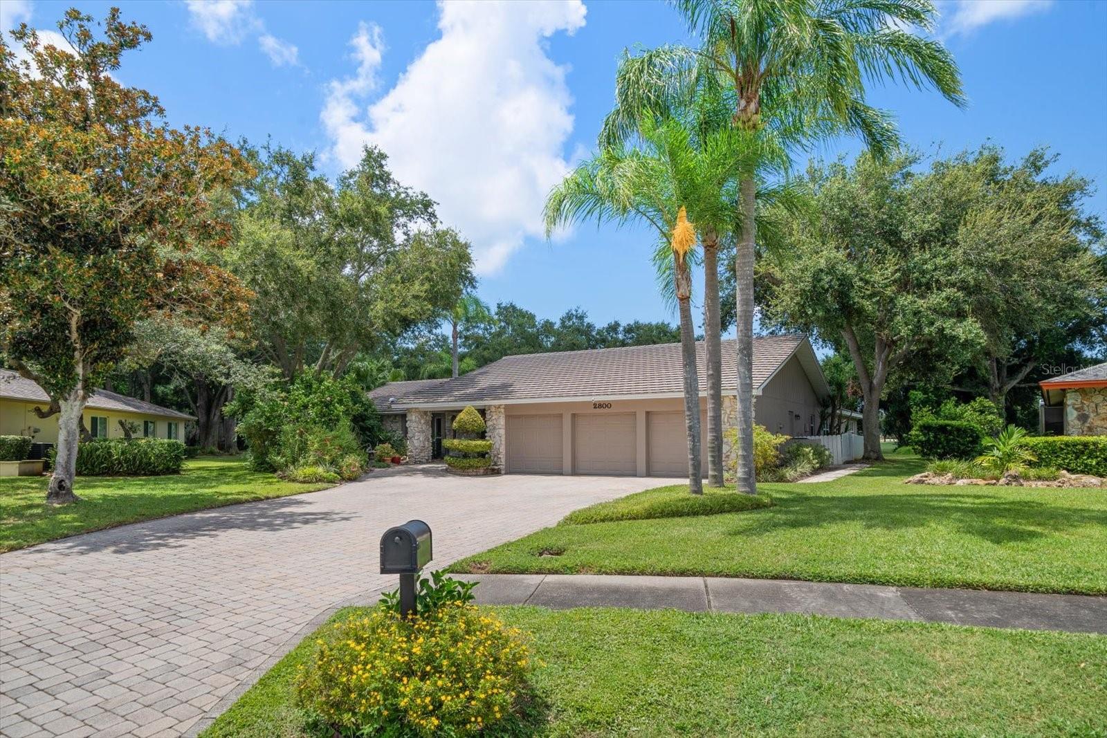 Front of this 3 BR home with 3 car garage and paver driveway