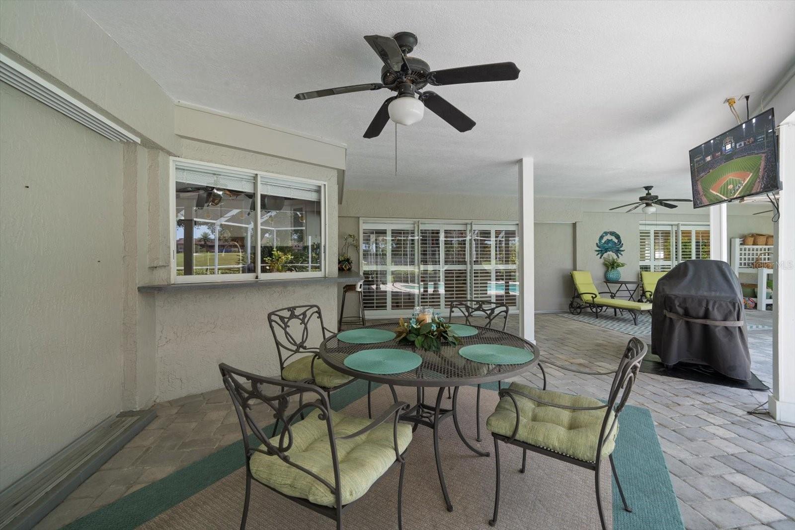 Spacious back patio with ceiling fans, right off the kitchen and family room.