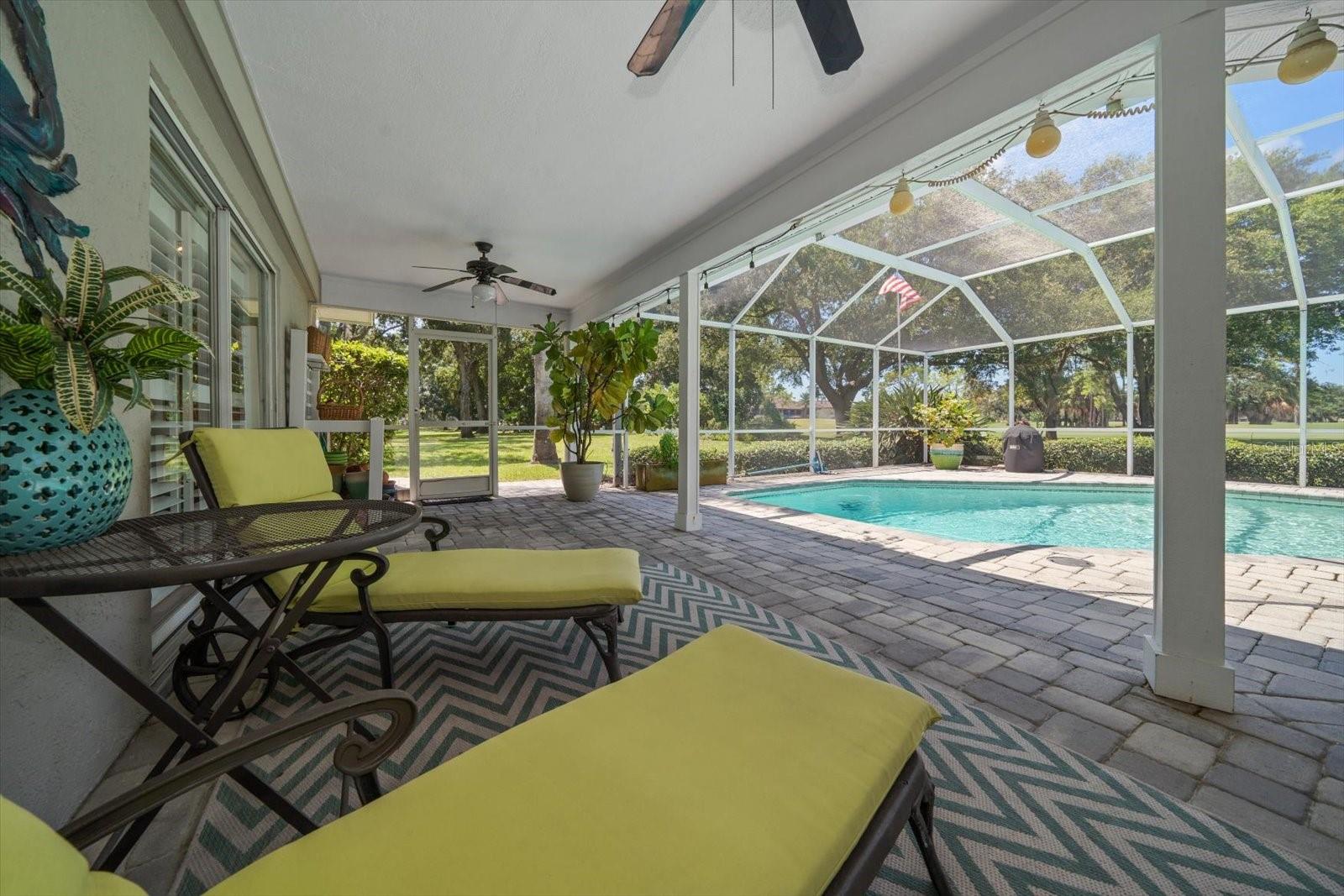 Covered back patio overlooking the pool and golf course