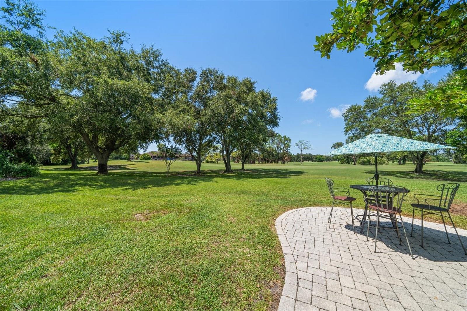 Another patio outside of the screen enclosure, overlooking the golf course