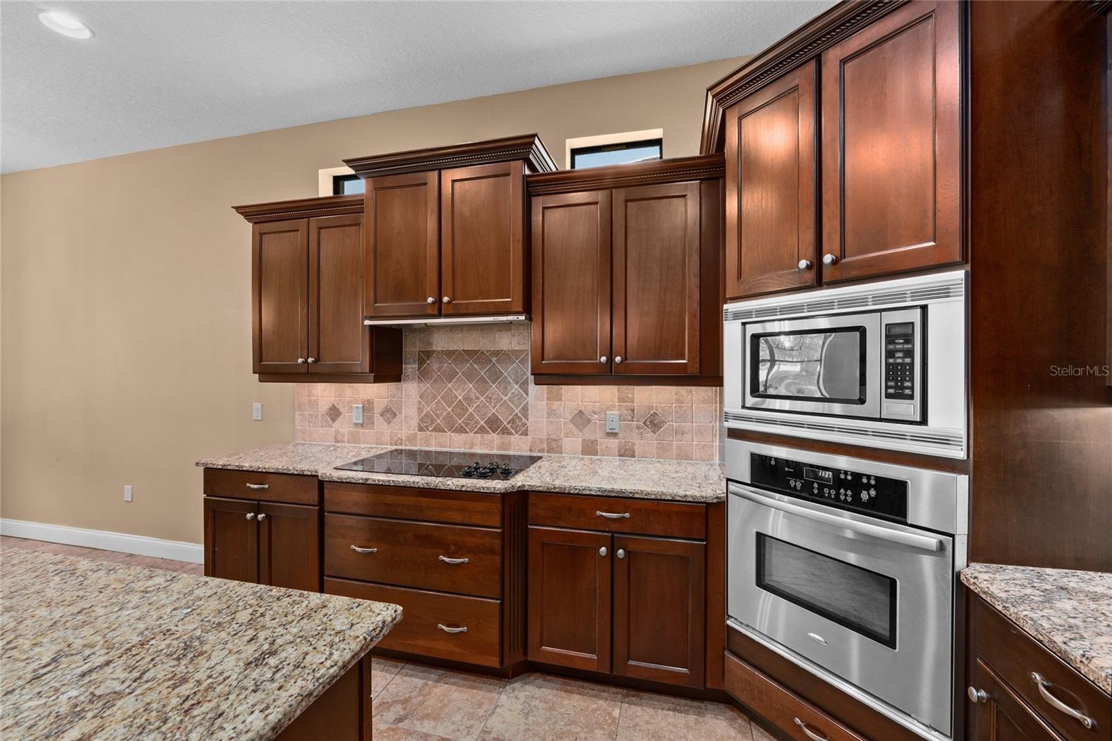 Wood cabinets, stainless steel appliances, and granite countertops