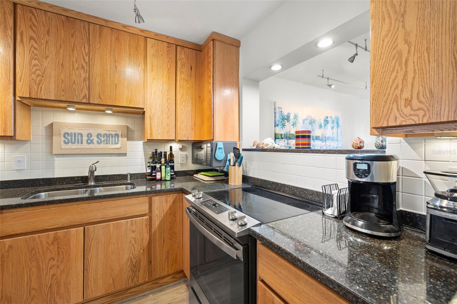 Kitchen has an opening to the dining and living area