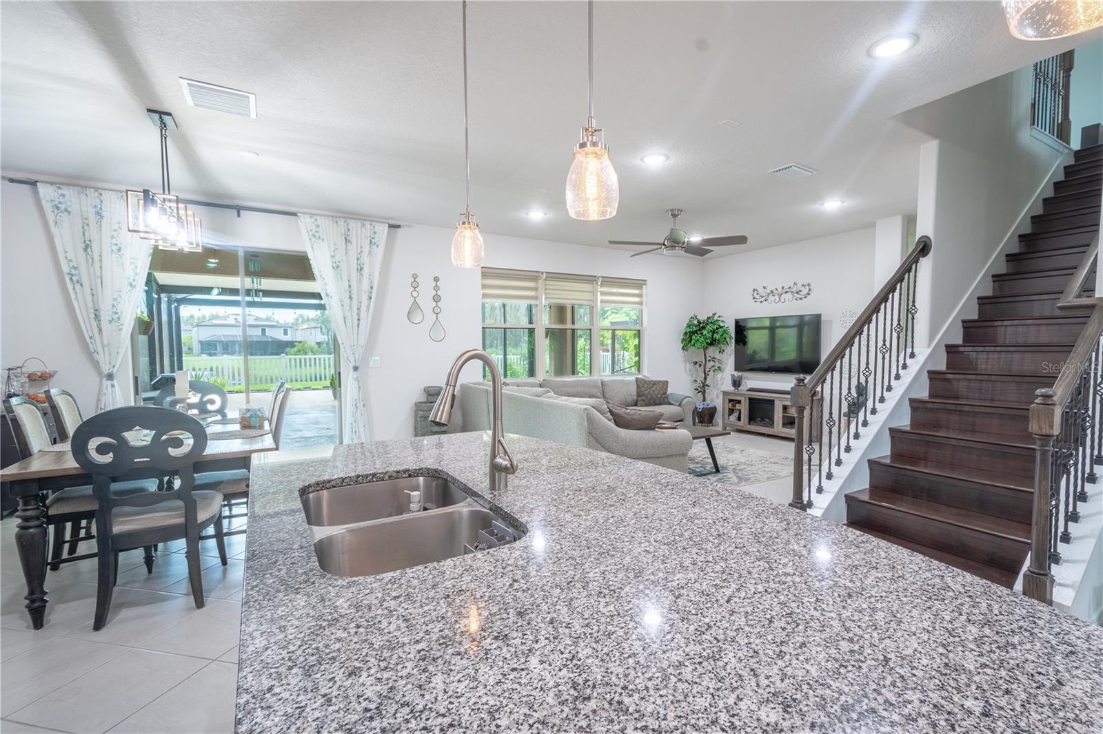 Rich, dark wood laminate flooring and a stylish bannister leads upstairs.