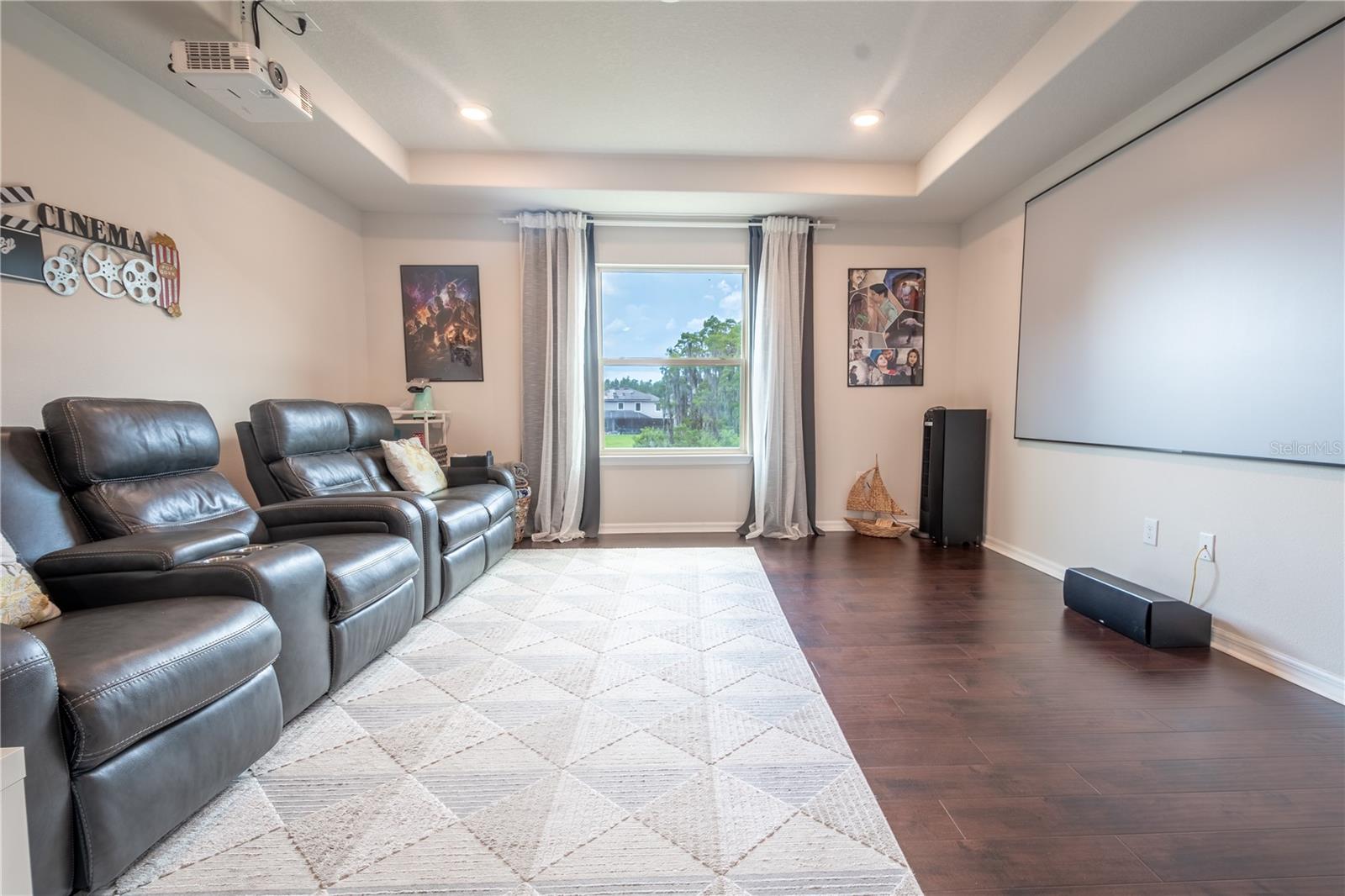 Upstairs, the large loft is currently used as a home theatre. This space could also be used as a den, home office, gym or playroom.