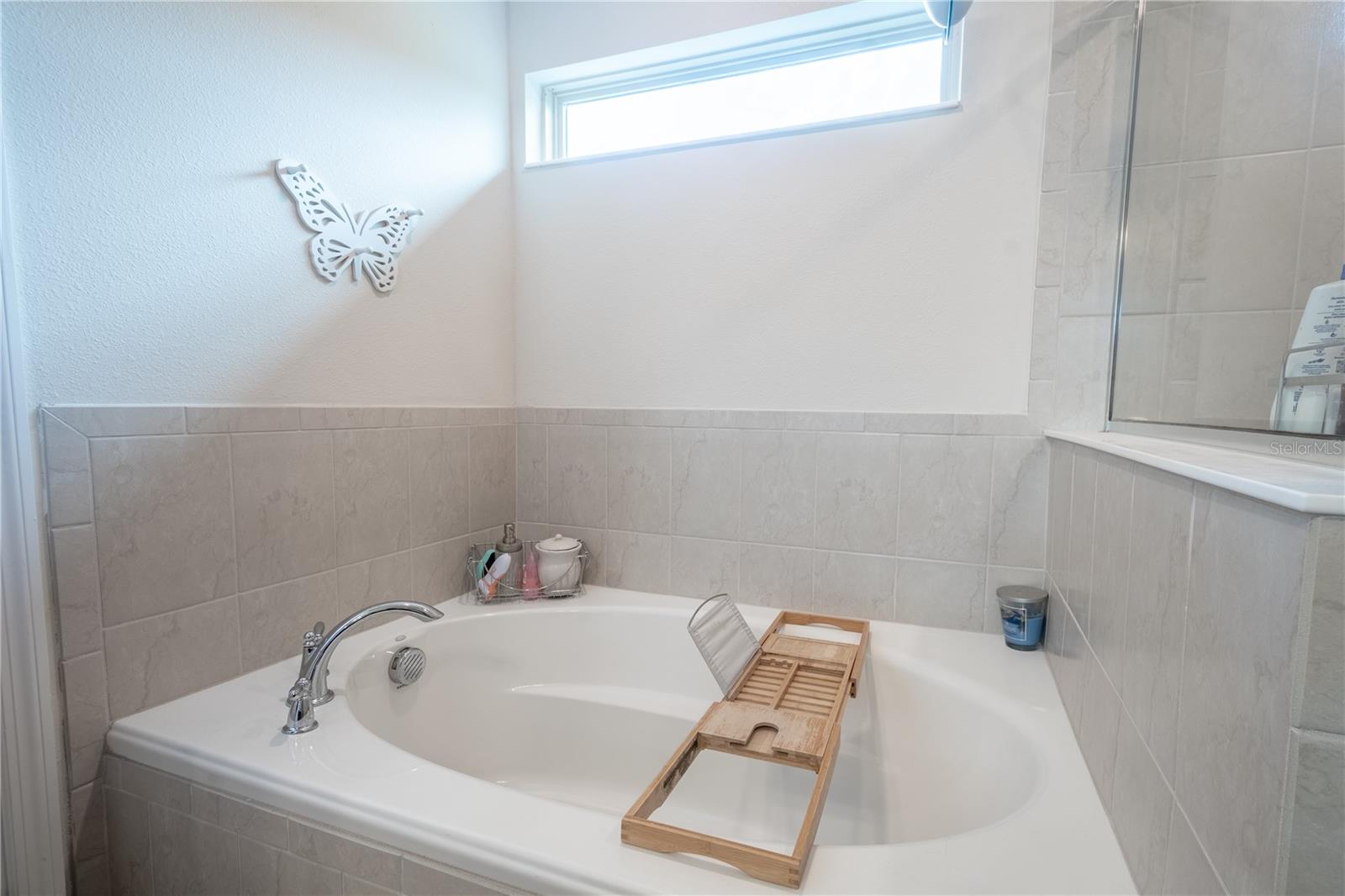 The primary bath features a garden tub with transom window above.