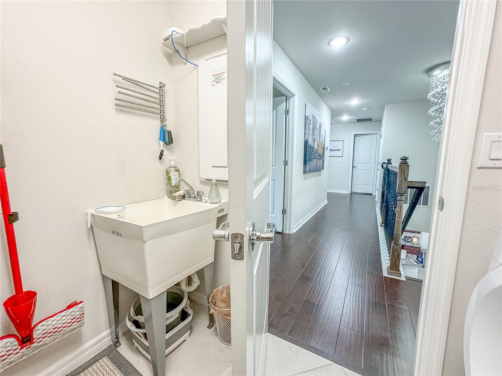 The laundry room features a utility sink.