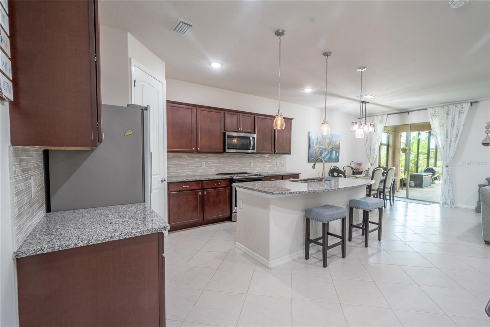 The kitchen is open to the family and dining rooms.