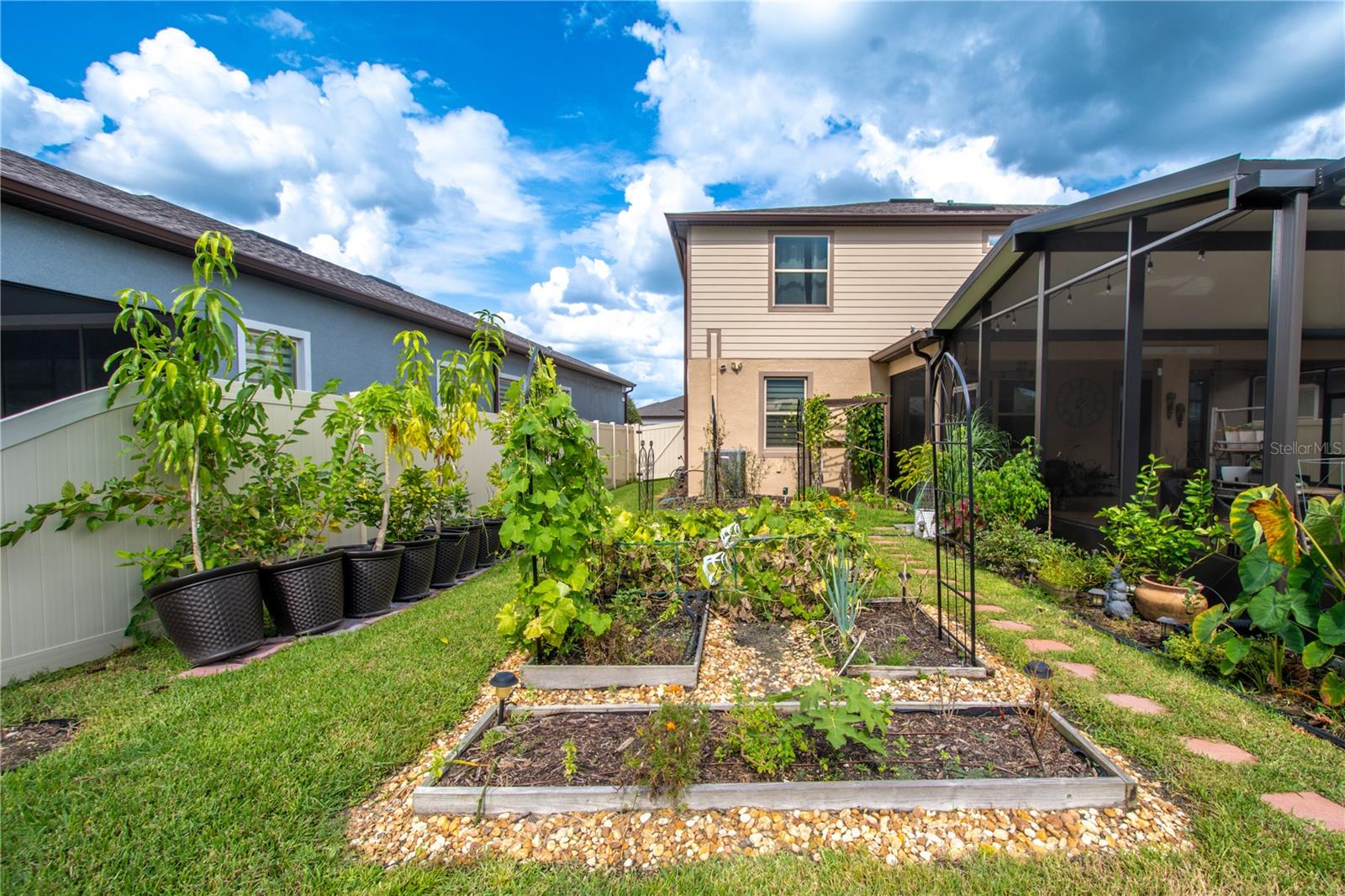 The home has a raised bed vegetable and herb garden.