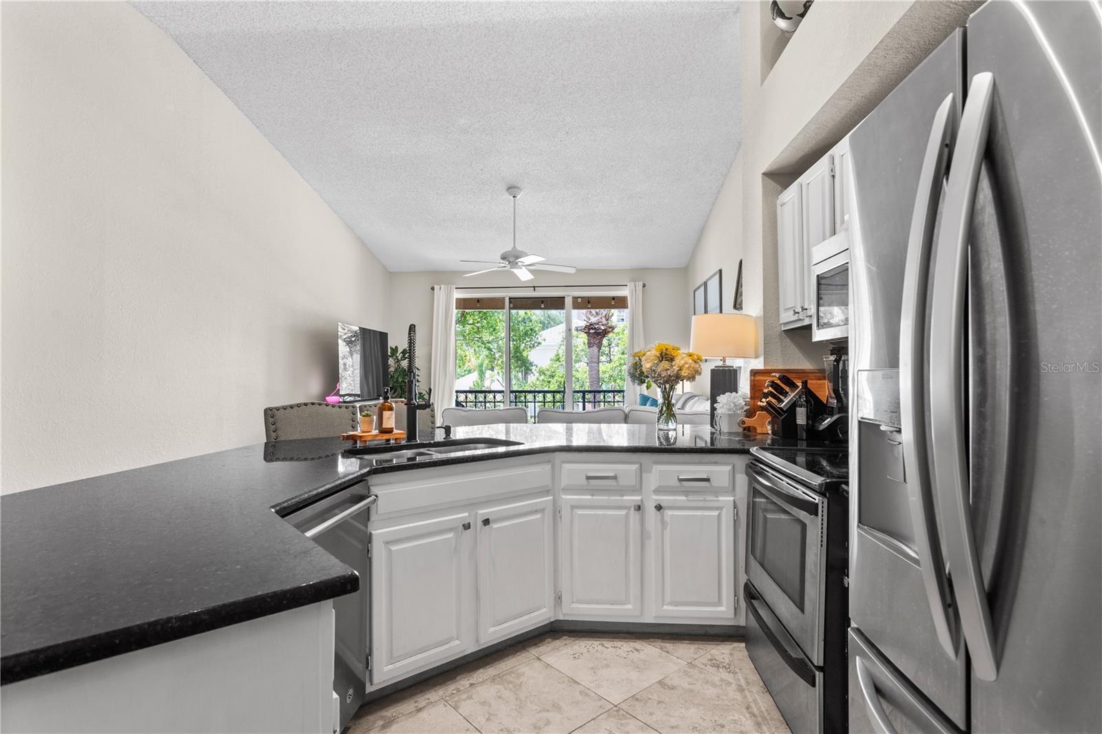 Stone counters and stainless appliances grace the roomy kitchen.