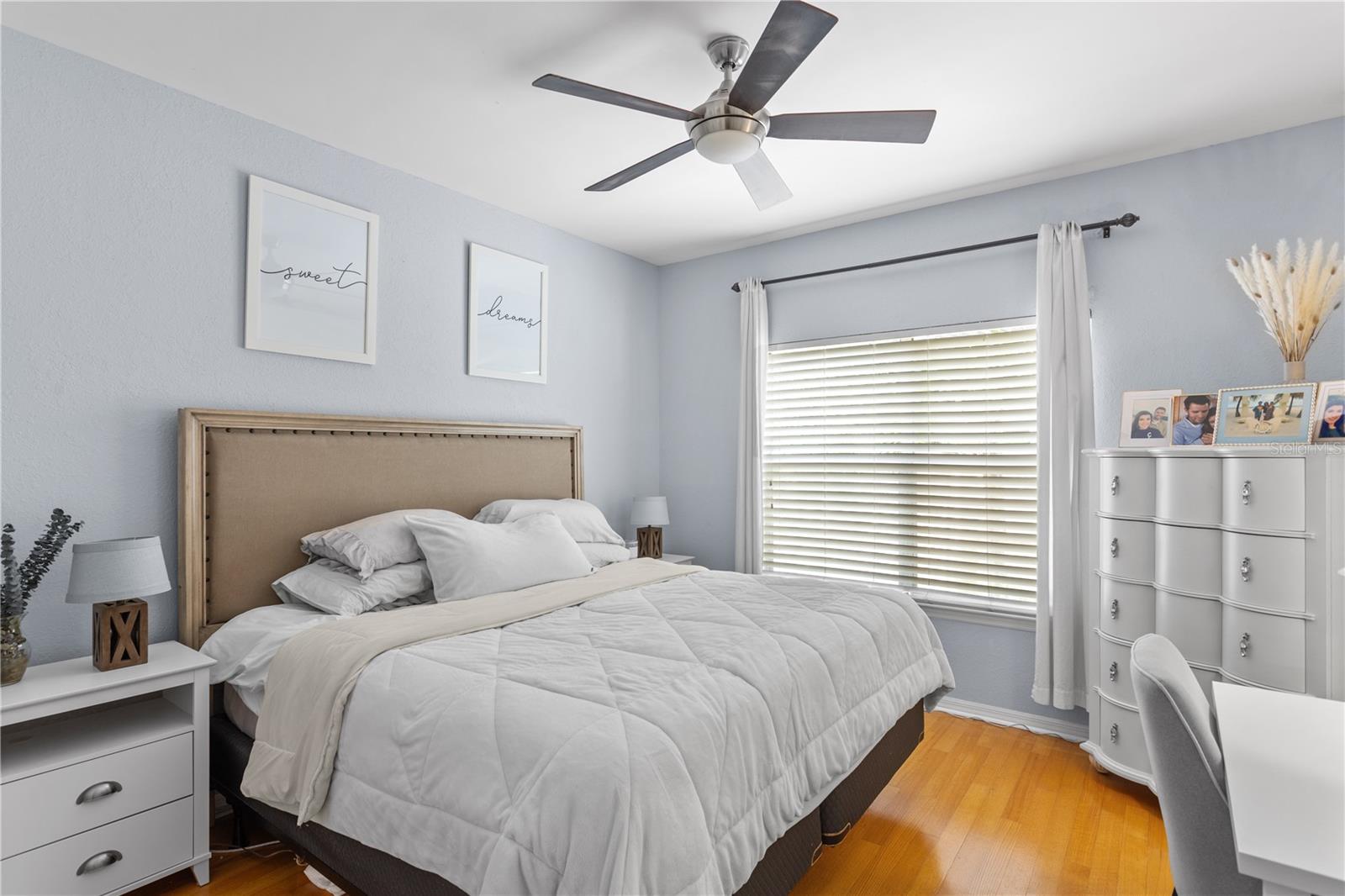 Muted colors and soft light grace the bedroom.