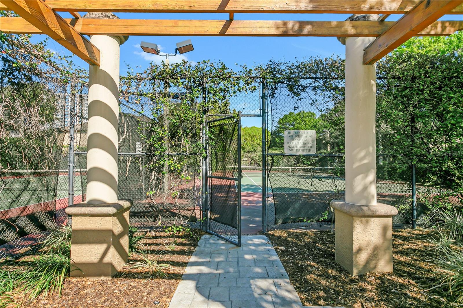 Two tennis courts sit in the middle of Island Walk.