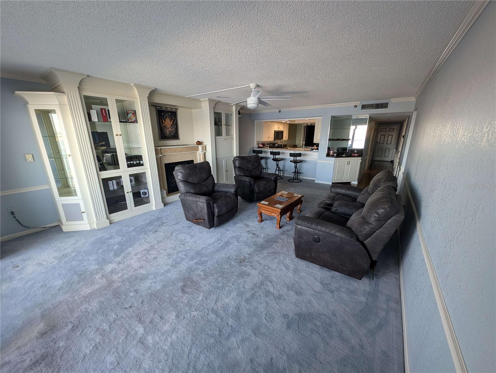 Living room with build in entertainment center and fireplace