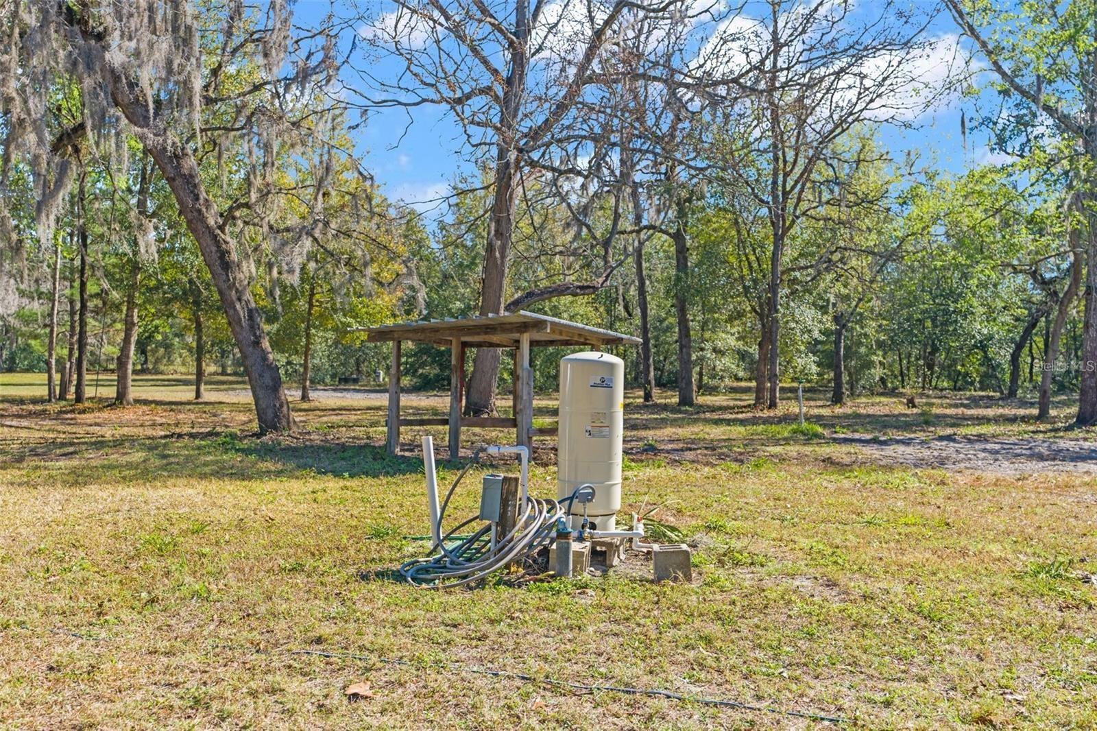 well and firewood shelter