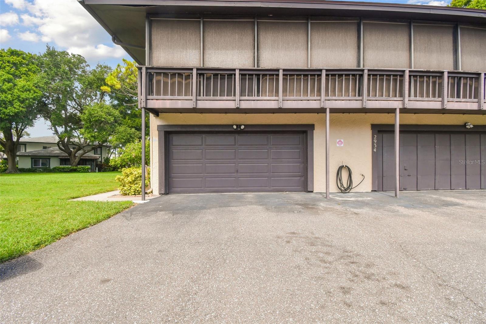 You get the left half of this two car garage (other half belongs to a neighbor), as well as the parking space in front of that half of the garage