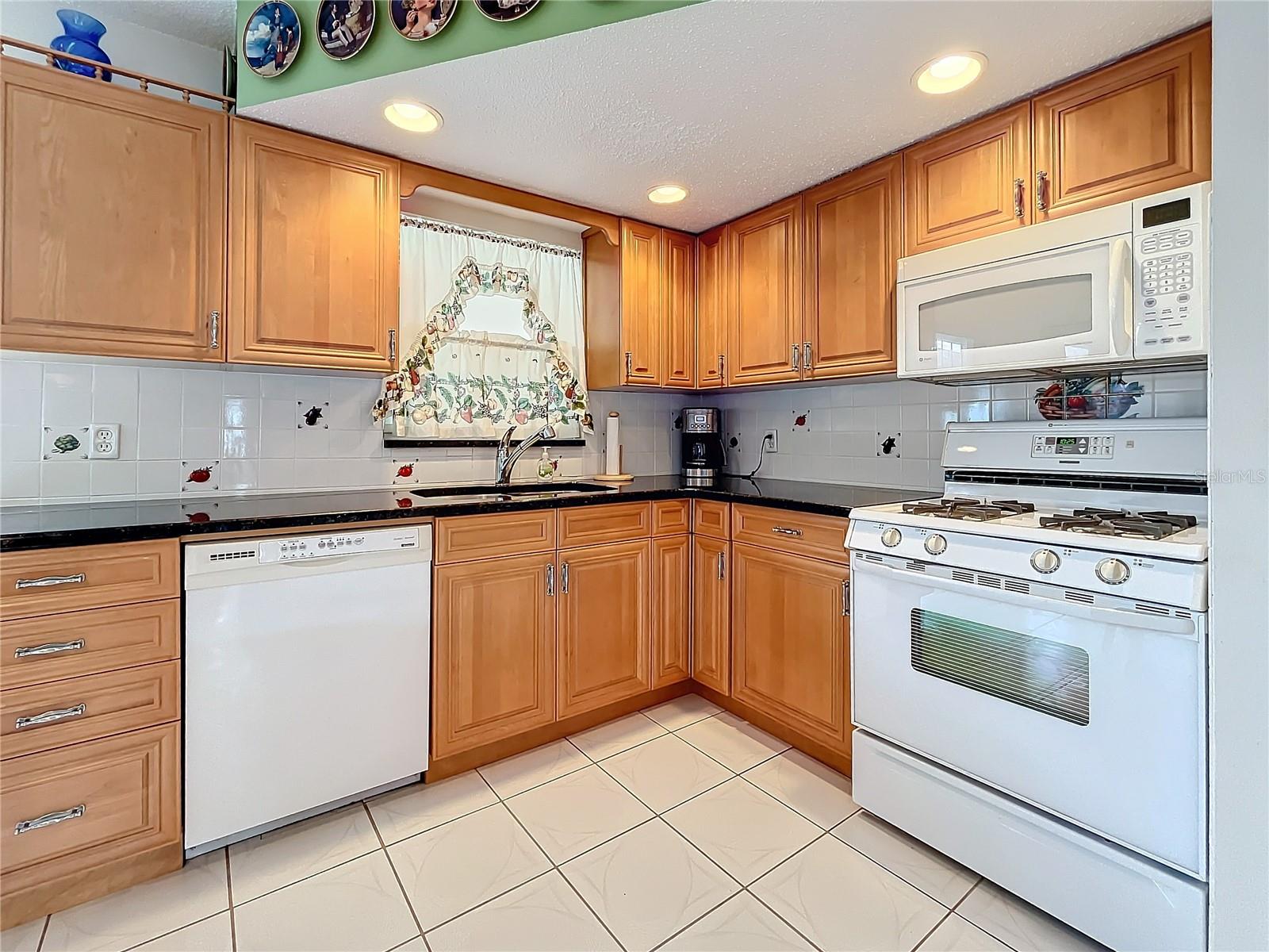 Nice kitchen with granite counters and natural gas stove