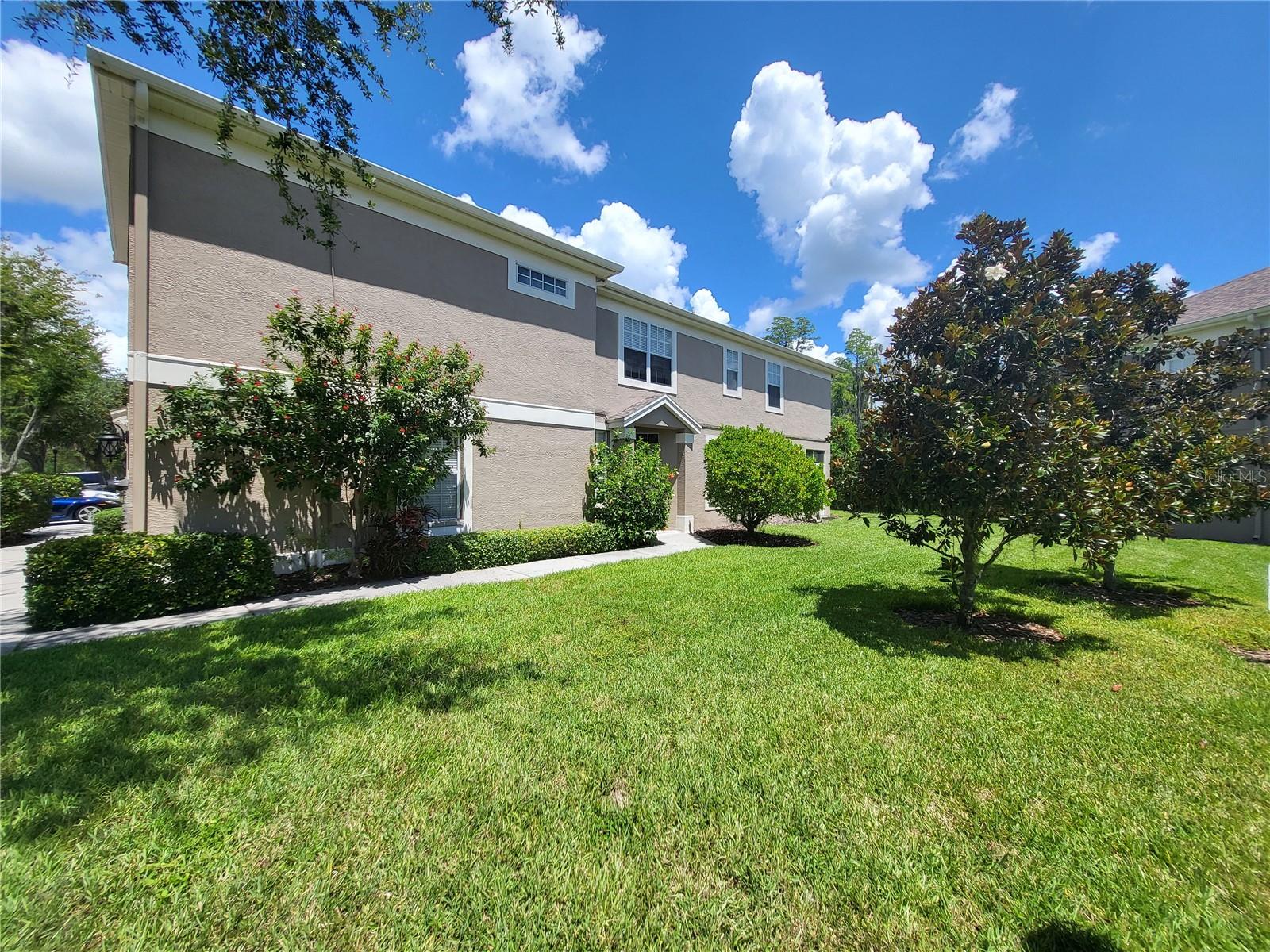 View of unit from side shows the private walkway up to private, covered entry