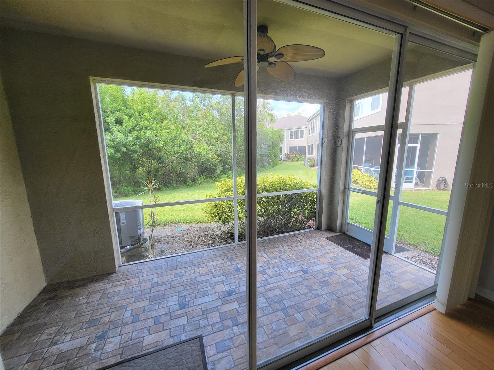 Spacious covered, screened patio has room for a table & chairs for dining al fresco during cooler months!