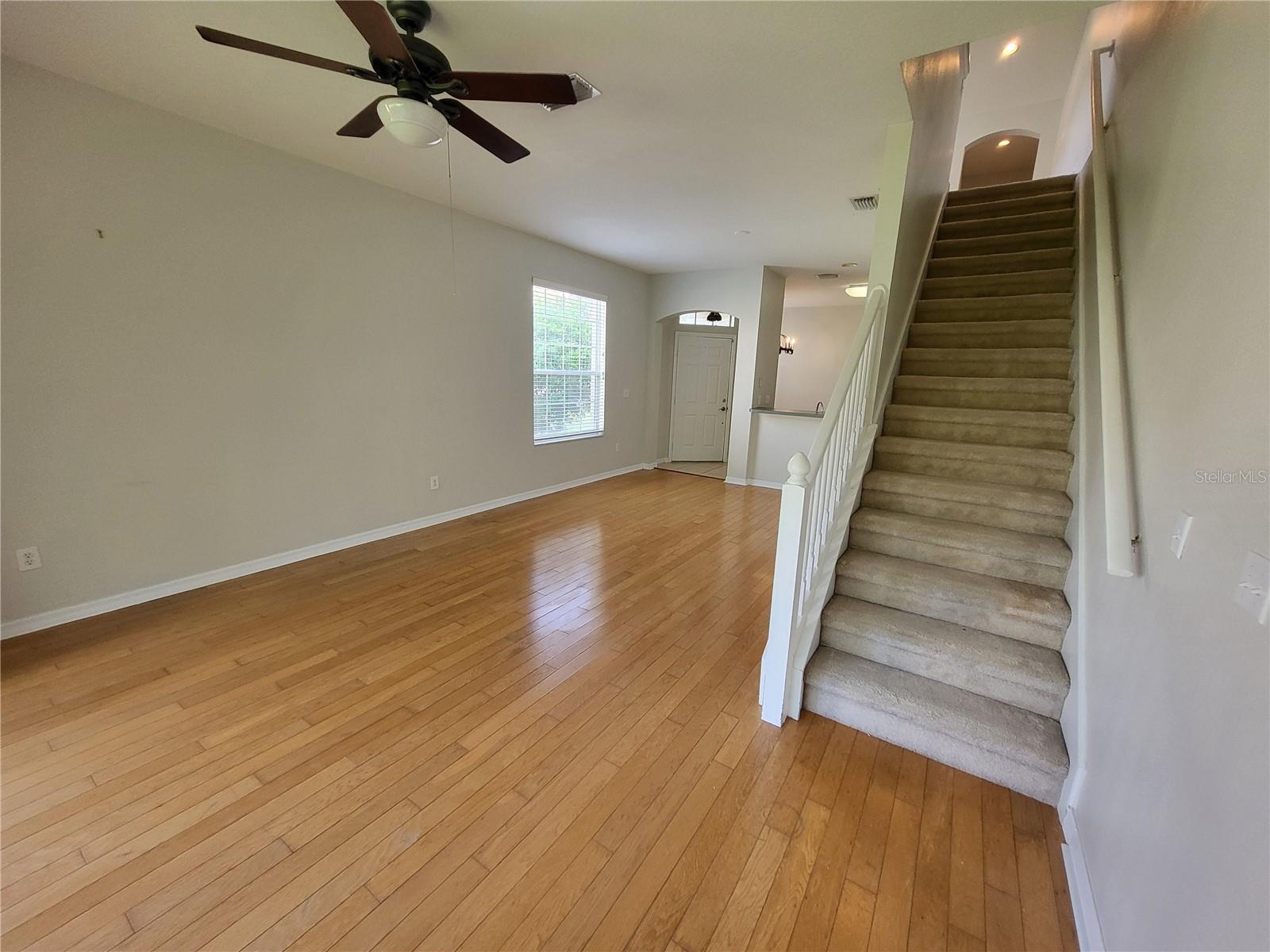 View of great room to front and up the stairs