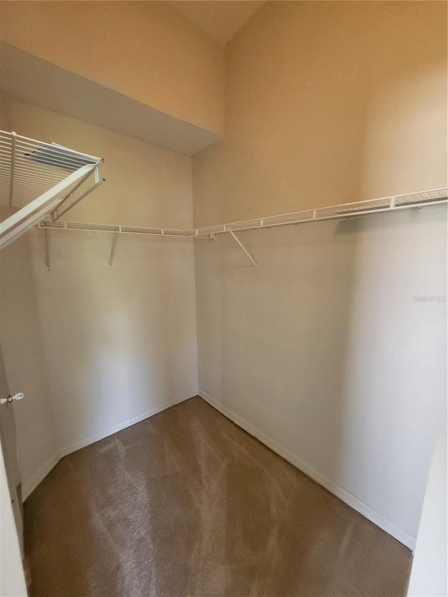 A custom built in closet system would be great here to help maximize the space and height of this walk-in closet