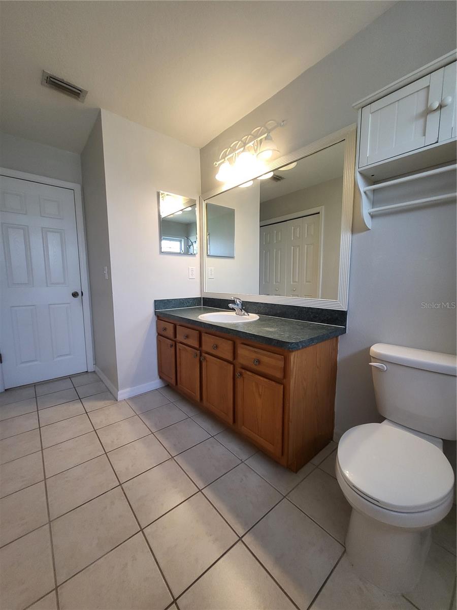 Secondary bathroom vanity has so much storage including several cabinets and drawers, a medicine cabinet and a wall cabinet