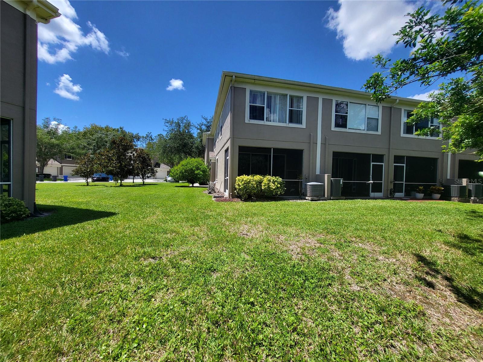 View of back of property-end unit.  Conveniently access backyard through screened patio if desired.  Great for taking the pup out!