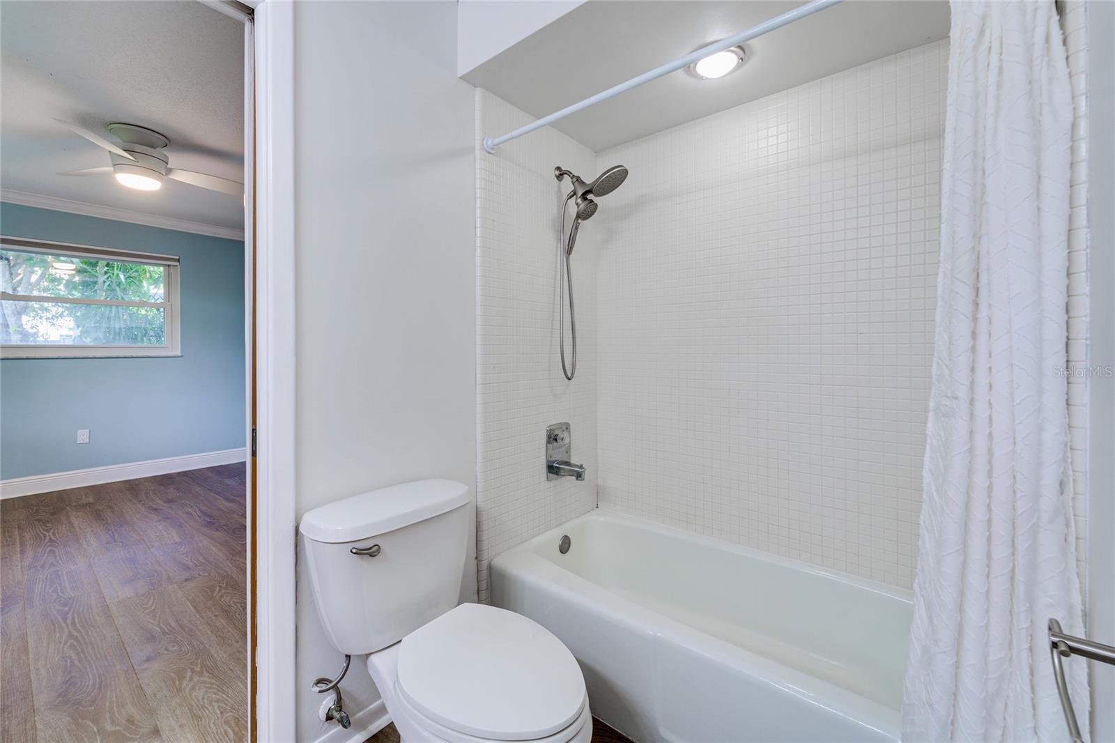 Shared bathroom with shower and bathtub.