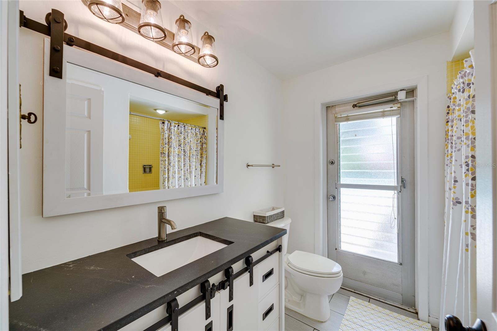 Pool bathroom with door to outside.