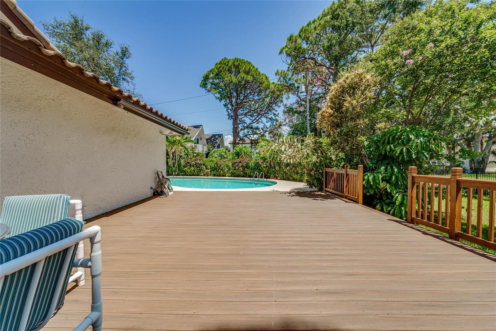 The enormous deck overlooking the newly fenced & sodded side yard and pool area.