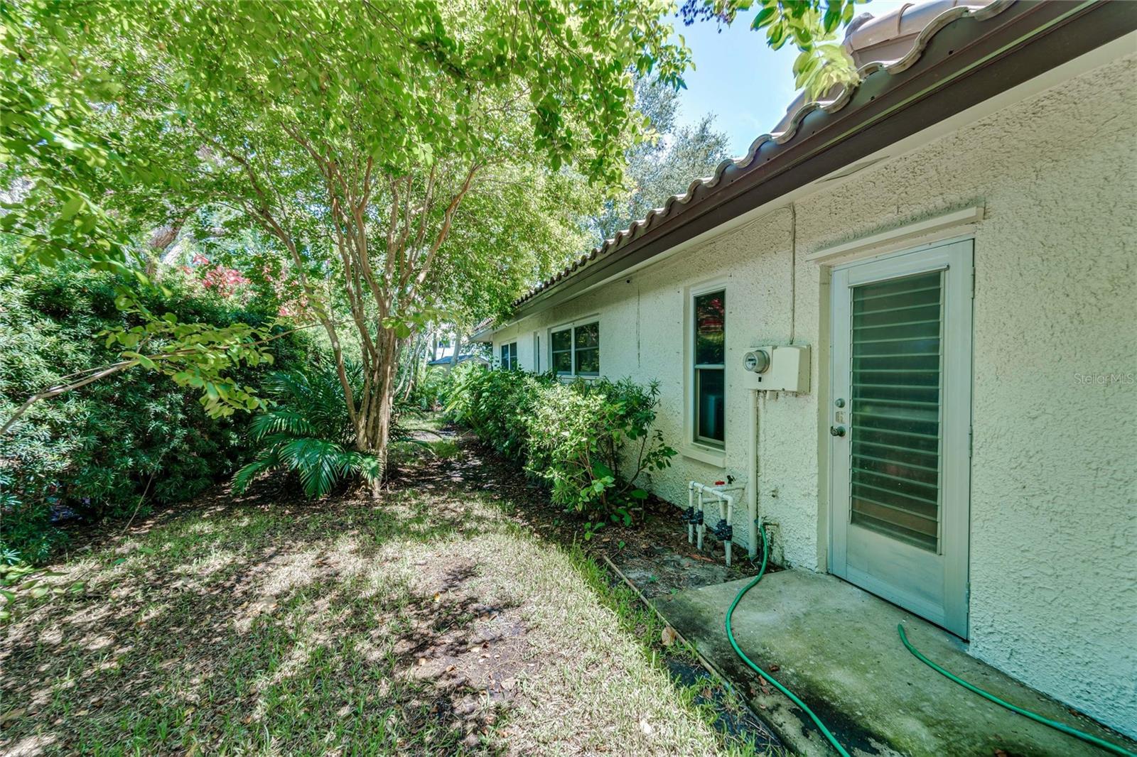 Side yard with side door to garage.