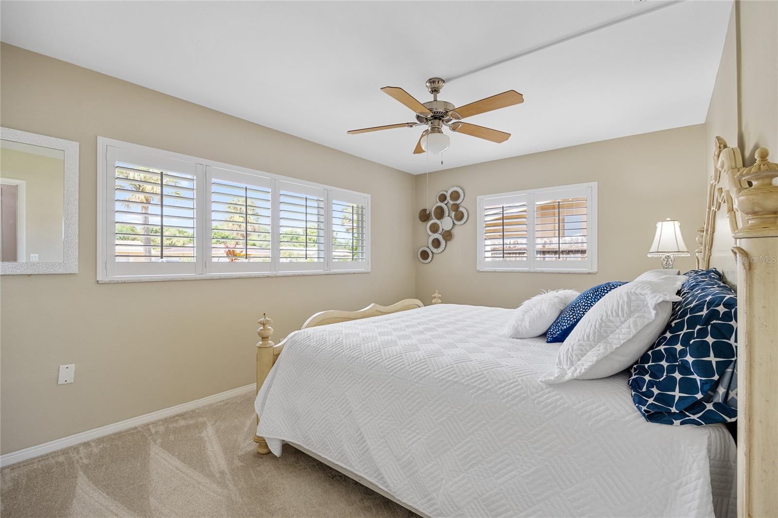 Primary Bedroom has large windows and brand new carpet.