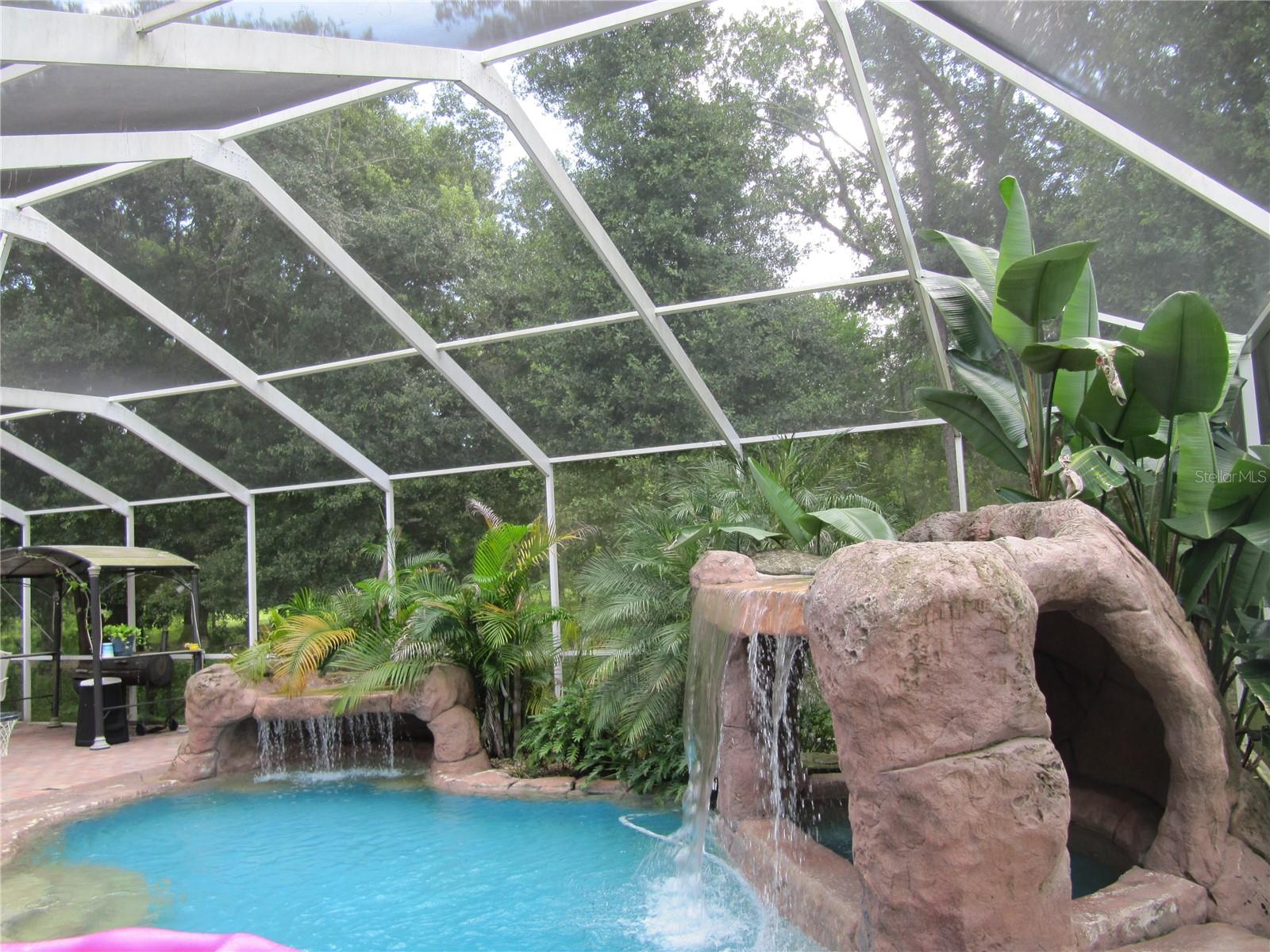 Gorgeous Pool with Disney style rock waterfalls.  Spa/hot tub under the waterfall on right.