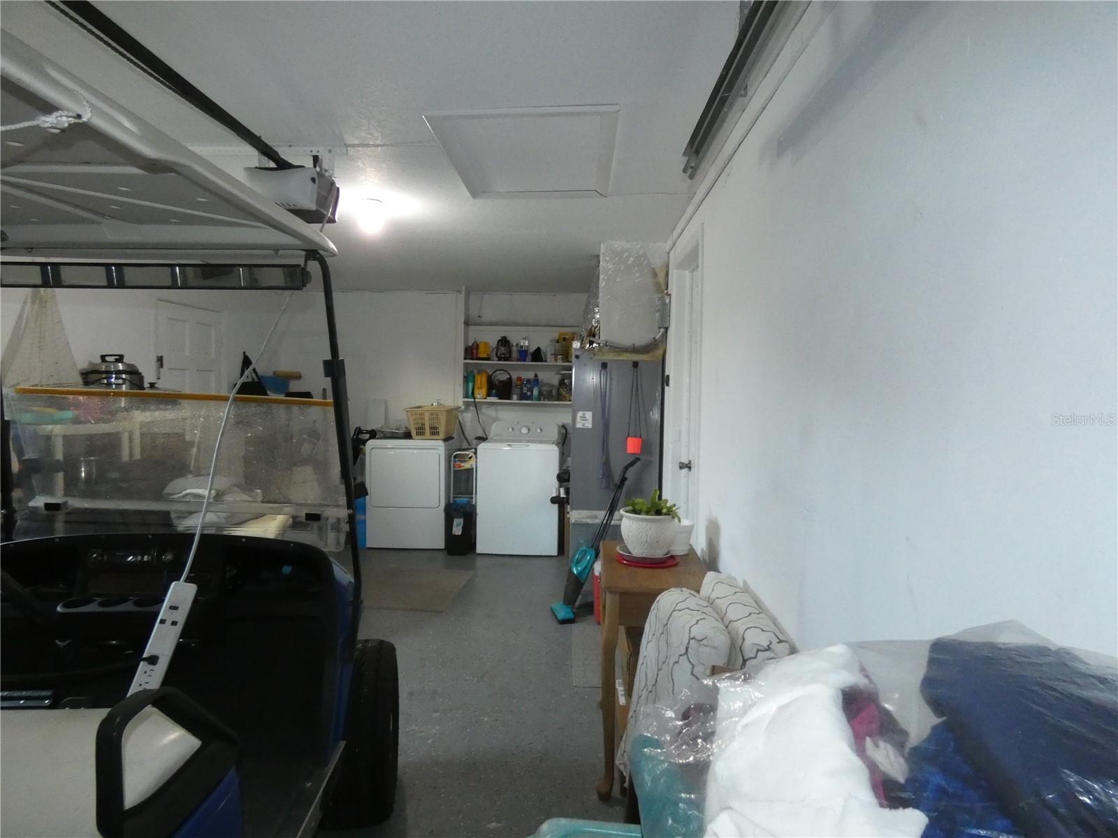 Washer/dryer in garage with nice epoxy flooring.