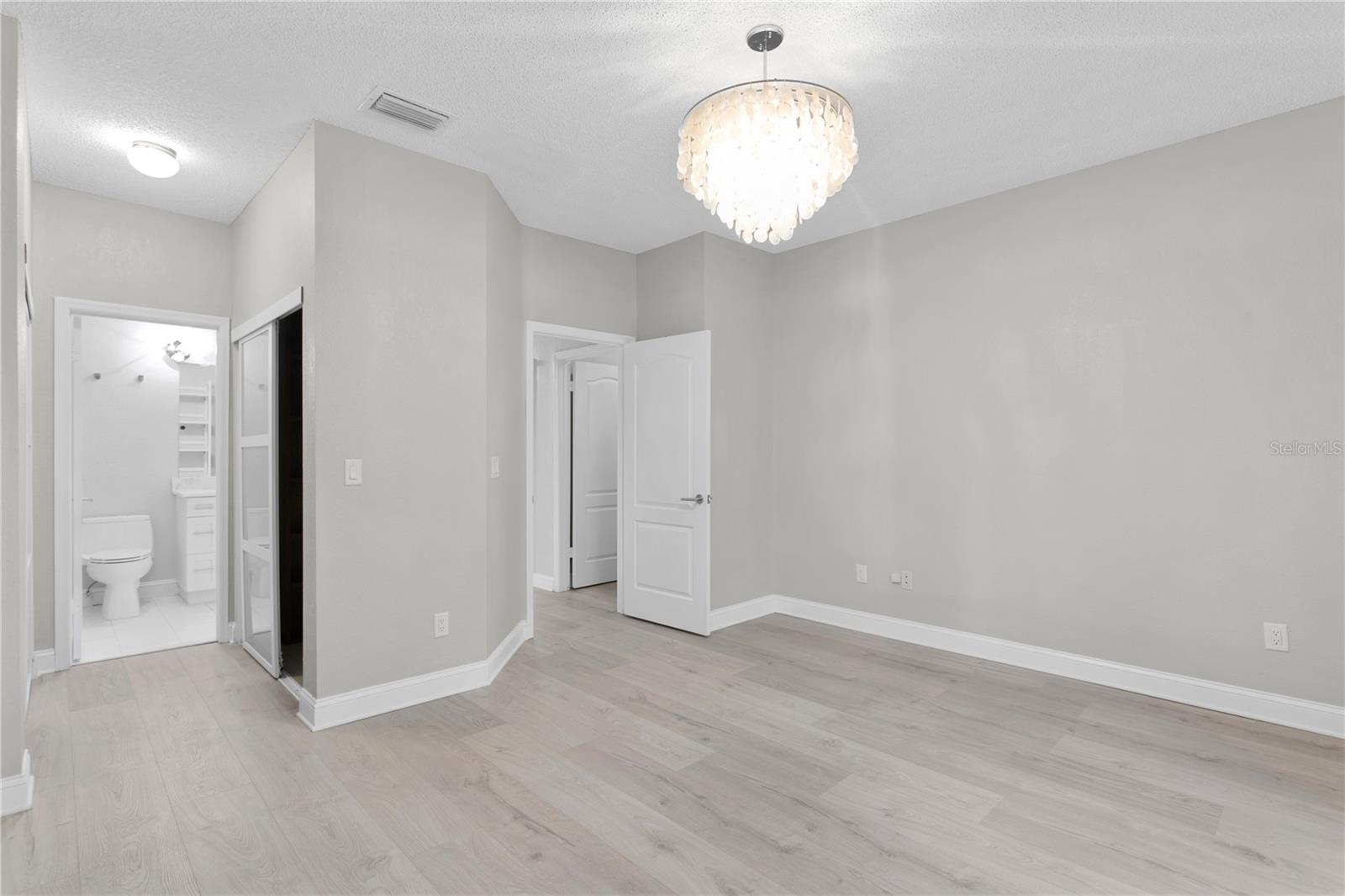 Primary bedroom with walk in closets and bathroom attached