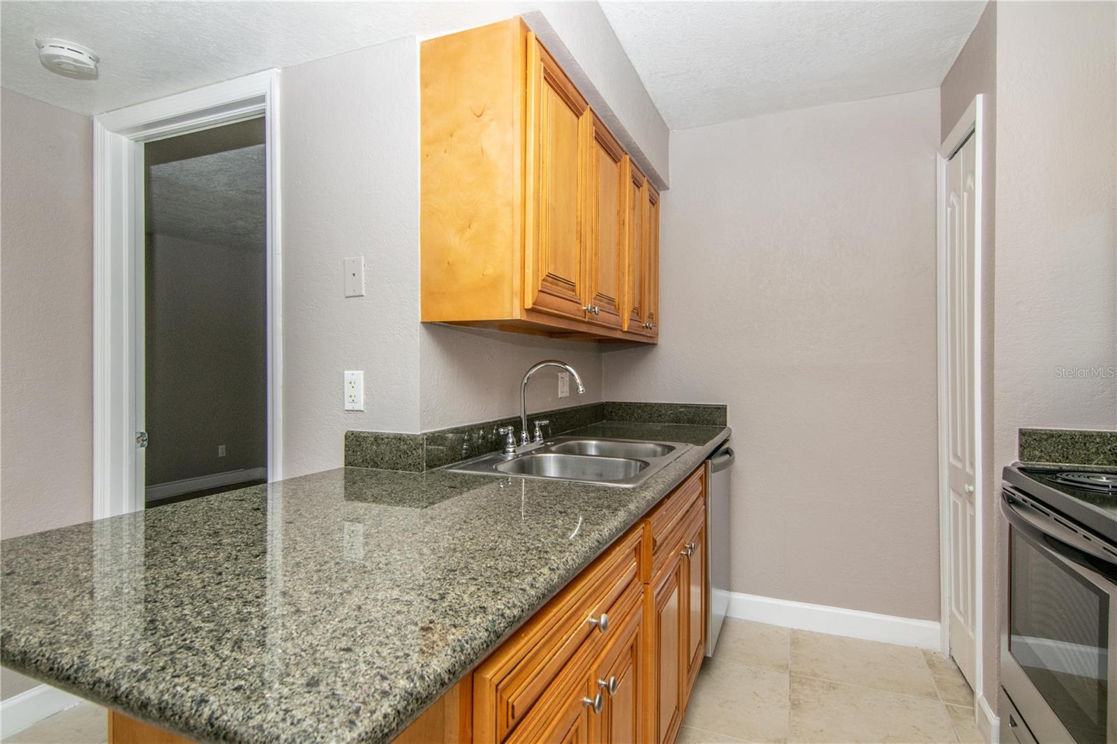 Kitchen w/ Wood Cabinets, Granite Counter-Tops, Stainless Steel Appliance Package