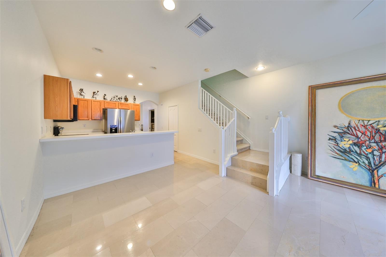 KITCHEN WITH BAR AND LARGE FAMILY ROOM.