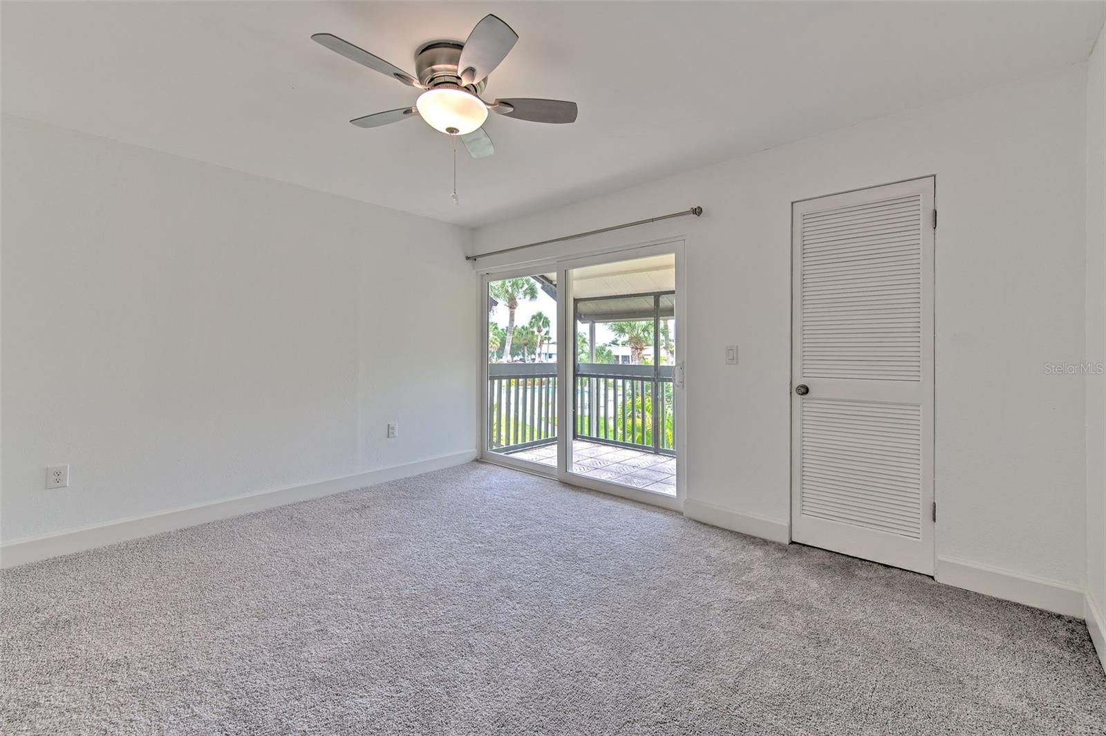 Upstairs primary bedroom with balcony