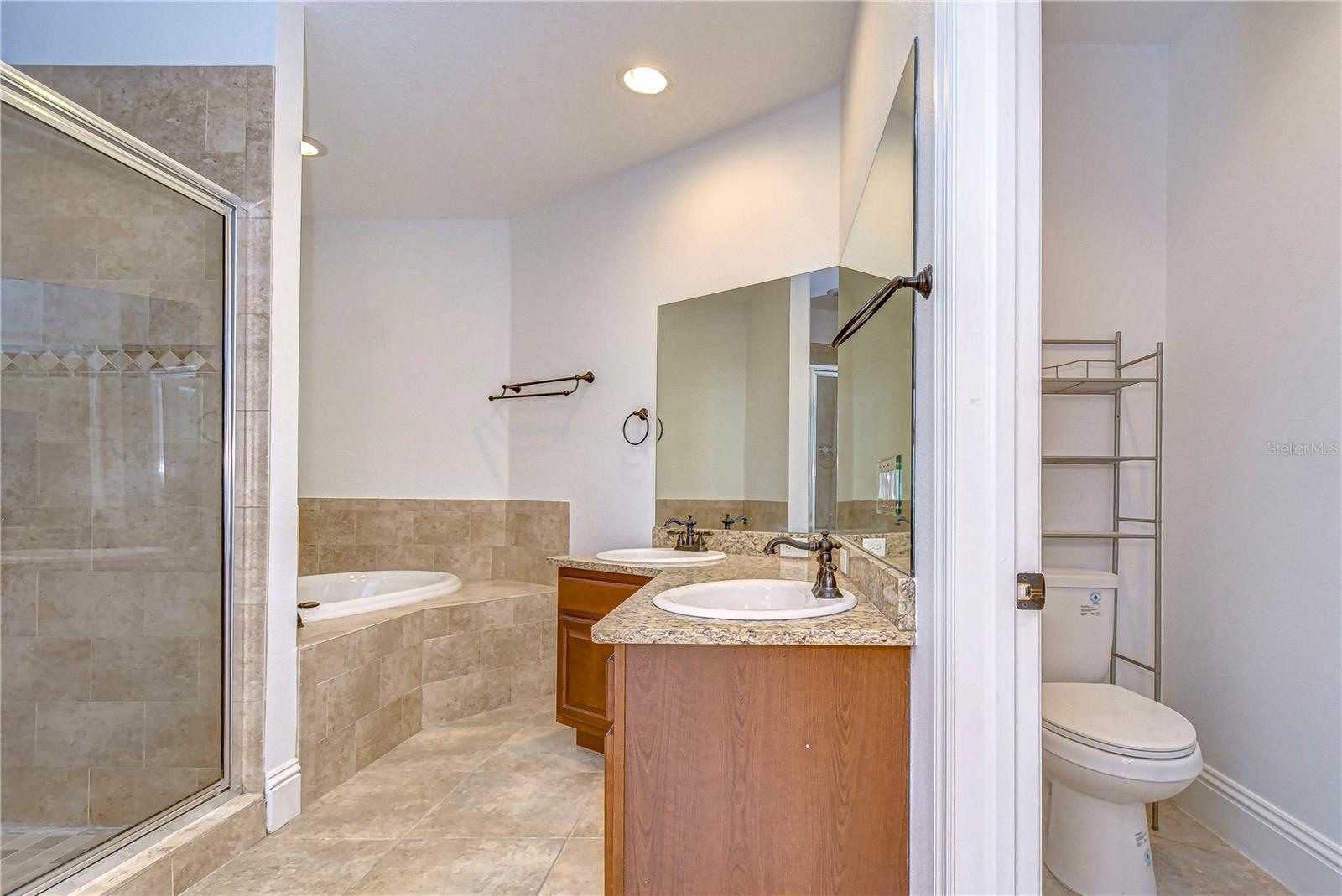 En-suite bathroom with granite counters and dual vanities!