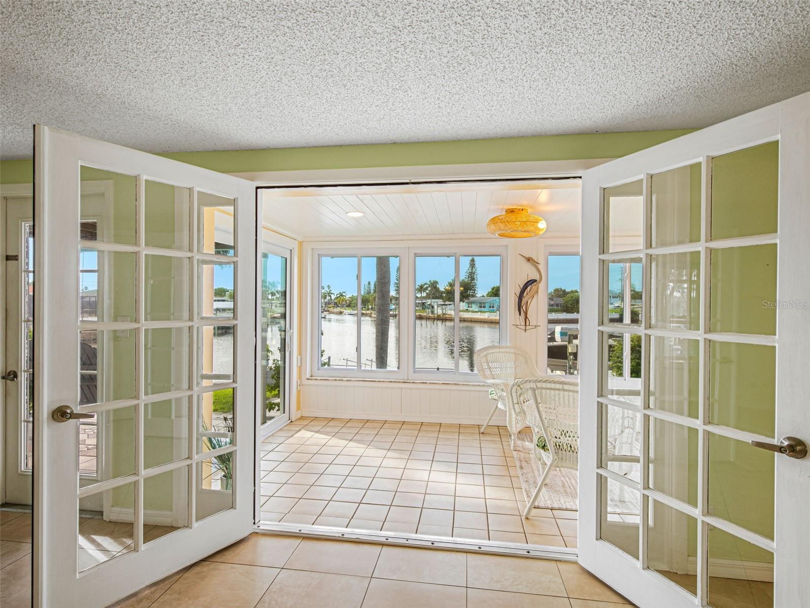 BEAUTIFUL FRENCH DOORS IN GREATROOM LOOKING TOWARDS LANAI & INLET