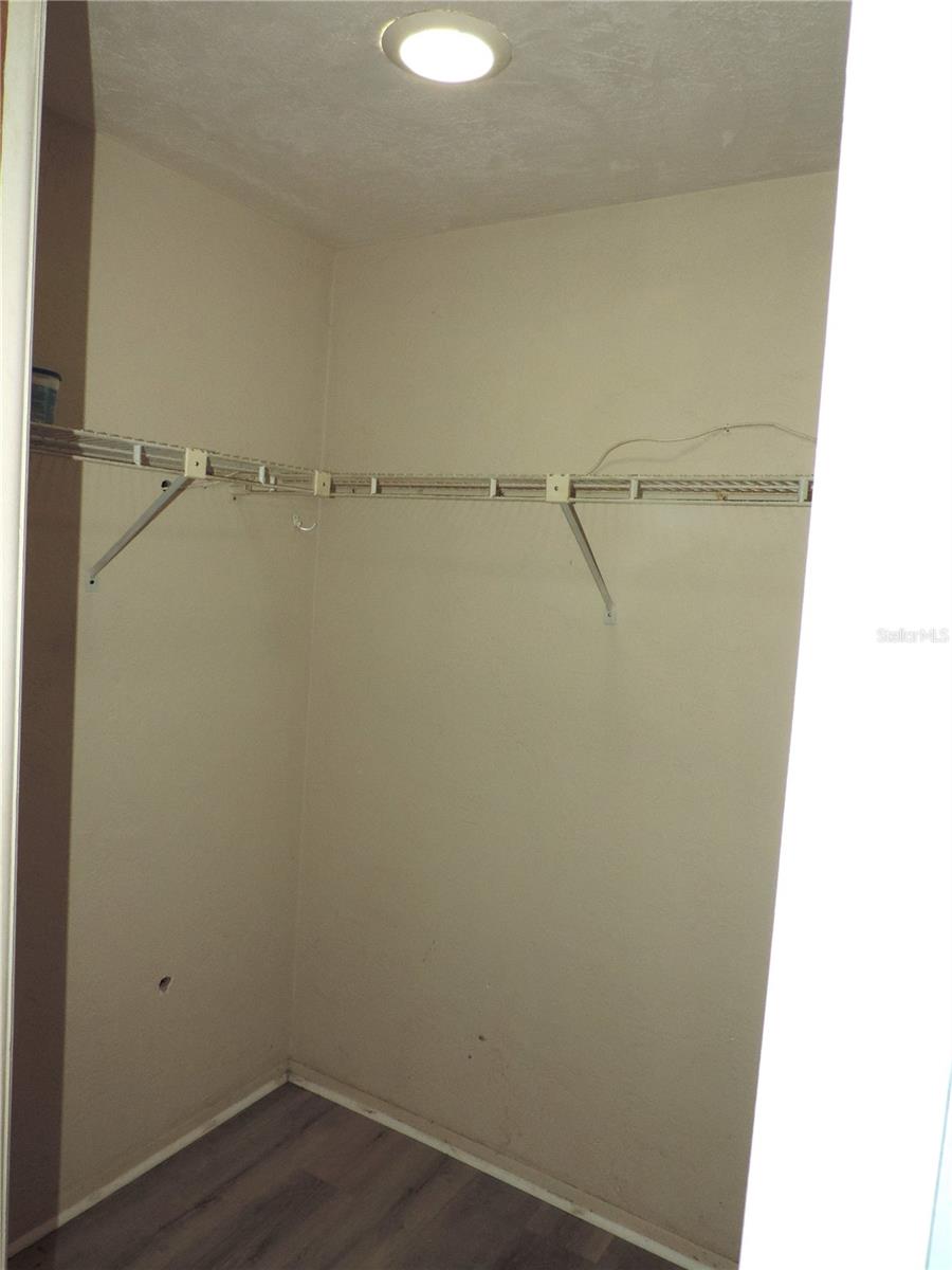 Primary bedroom walk in closet